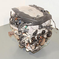 V6 engine on a gray surface with a white background