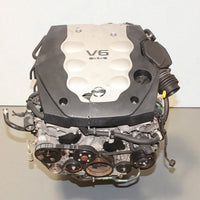 V6 engine on a gray surface with a white background